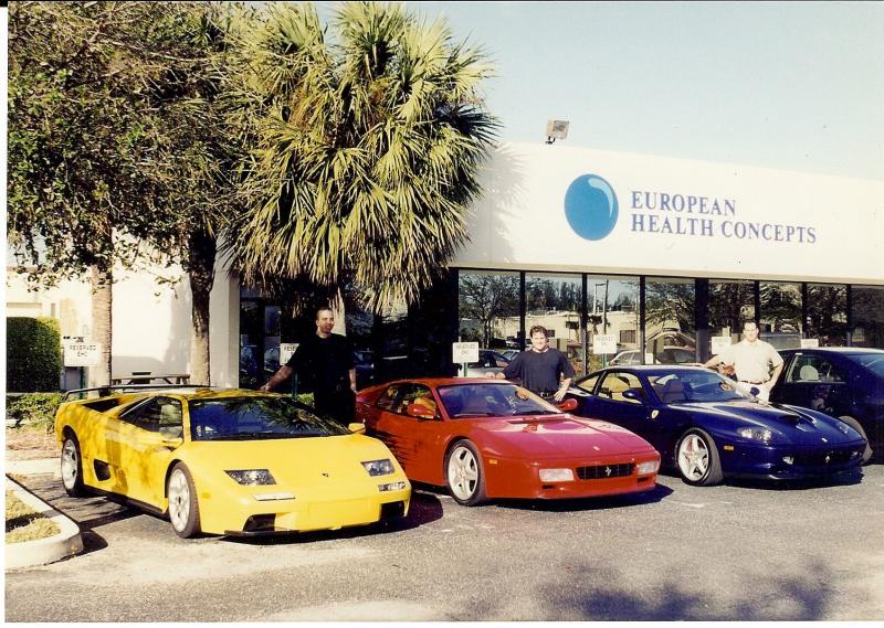 Peter_kevin___Lee_with_cars_in_front_of_their_EHC_building.jpg